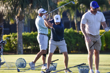 article image - Participants swing in Bricks & Sticks Golf Tournament 2025